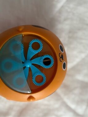 Orange Bubble Machine Toy with Blue Spinner